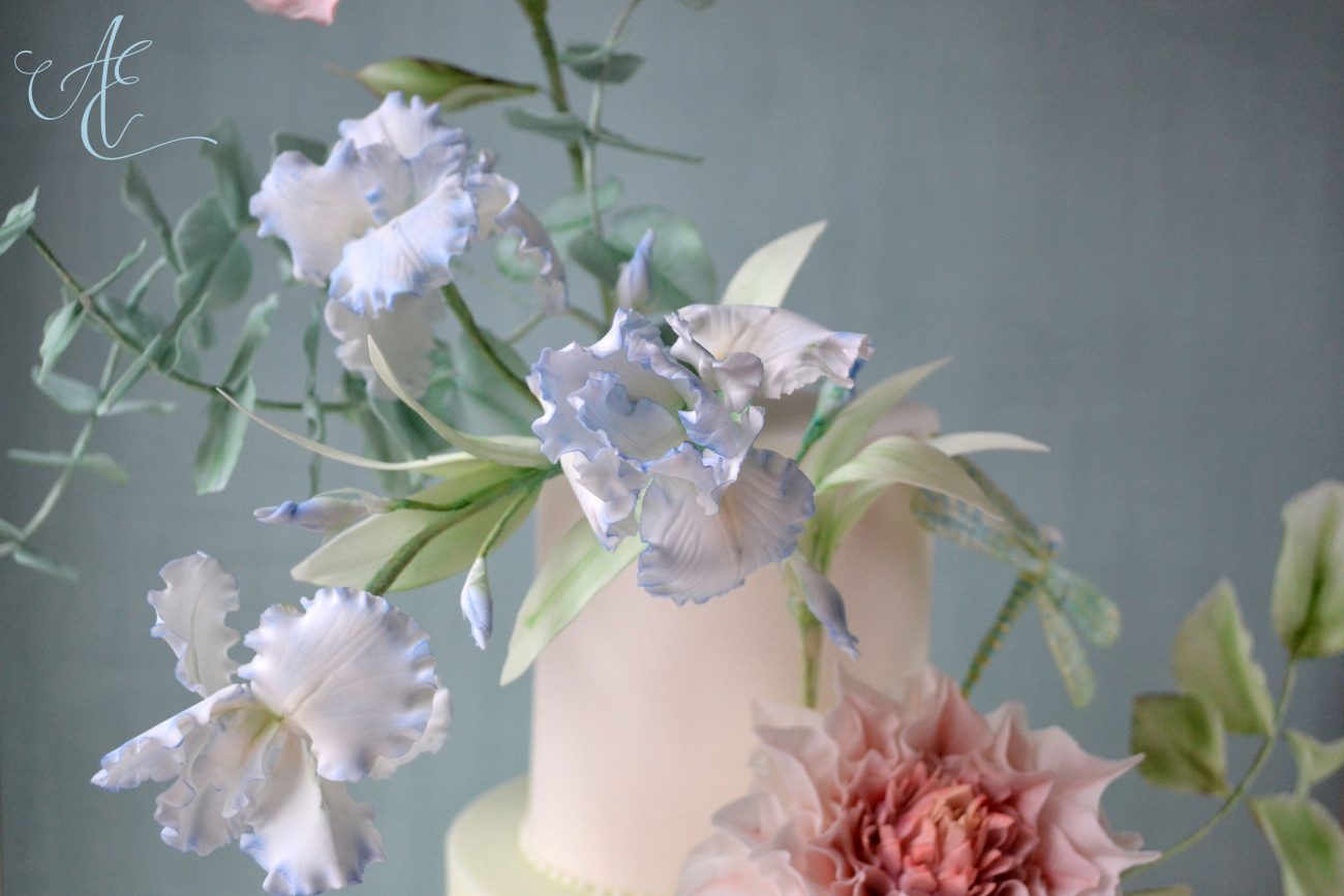 Sugared iris flowers on wedding cake by Amanda Earl