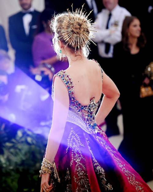 Back of Blake Lively, red and gold embroidered ball gown.