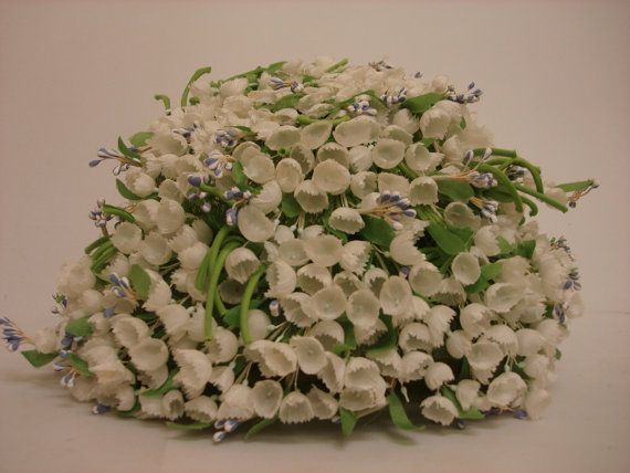 Hat decorated with artificial lilies of the valley silk flowers