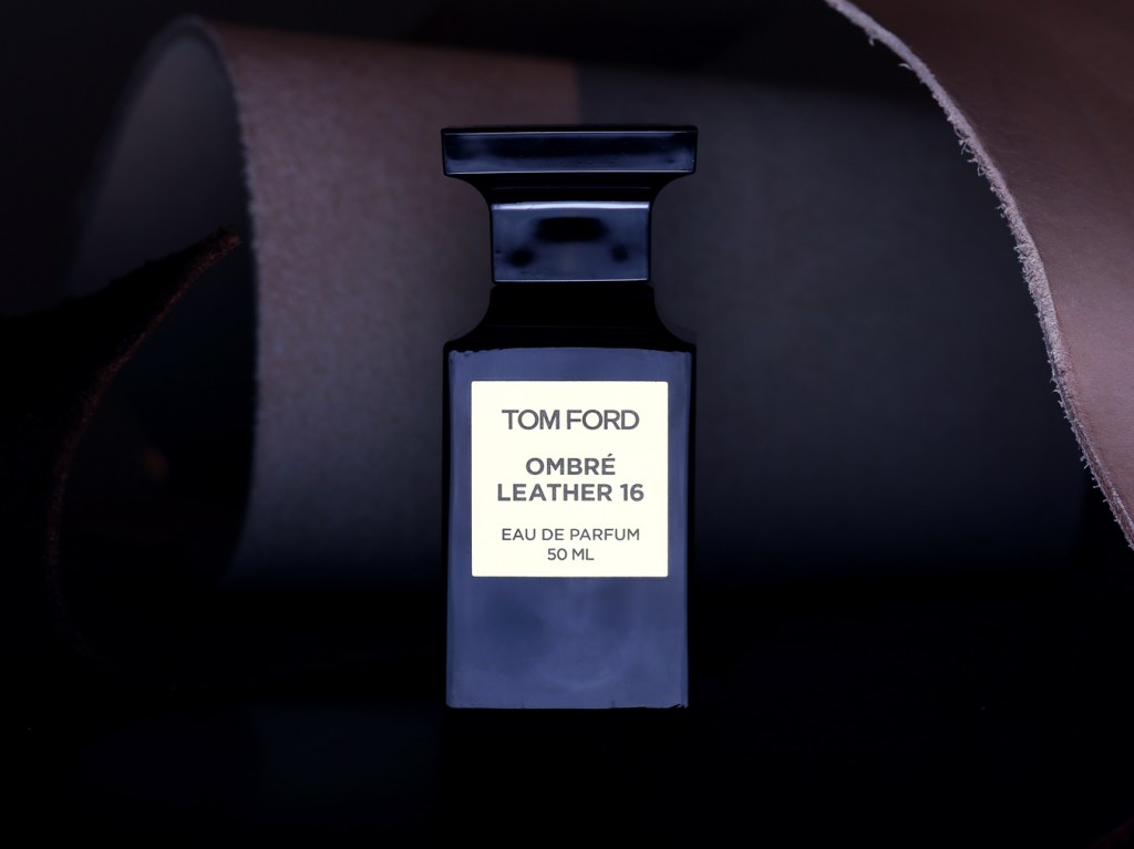 Bottle of Tom Ford's Ombré Leather eau de parfum against colored leather