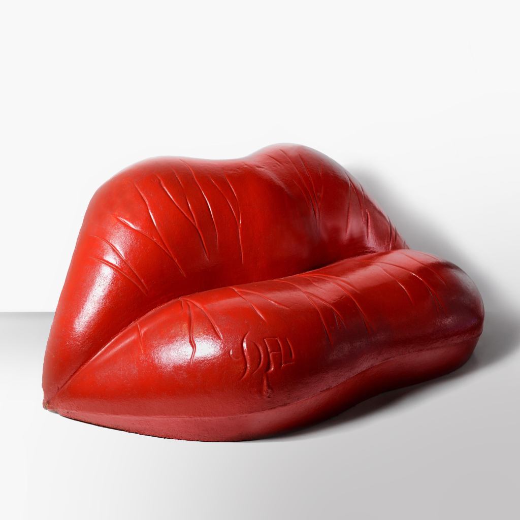 Red glossy vinyl sofa shaped like lips, by artist Salvador Dali