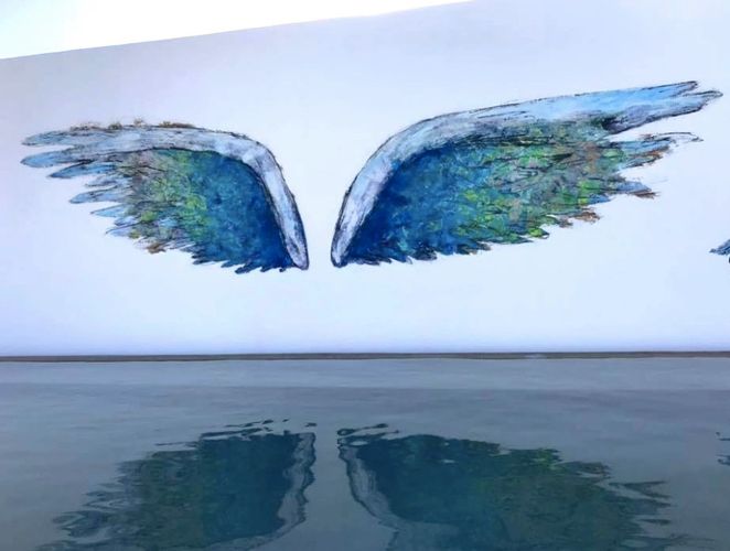 Painting of angel wings above water